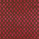 Detail of wallpaper in a repeating botanical grid print in red on a brown field.