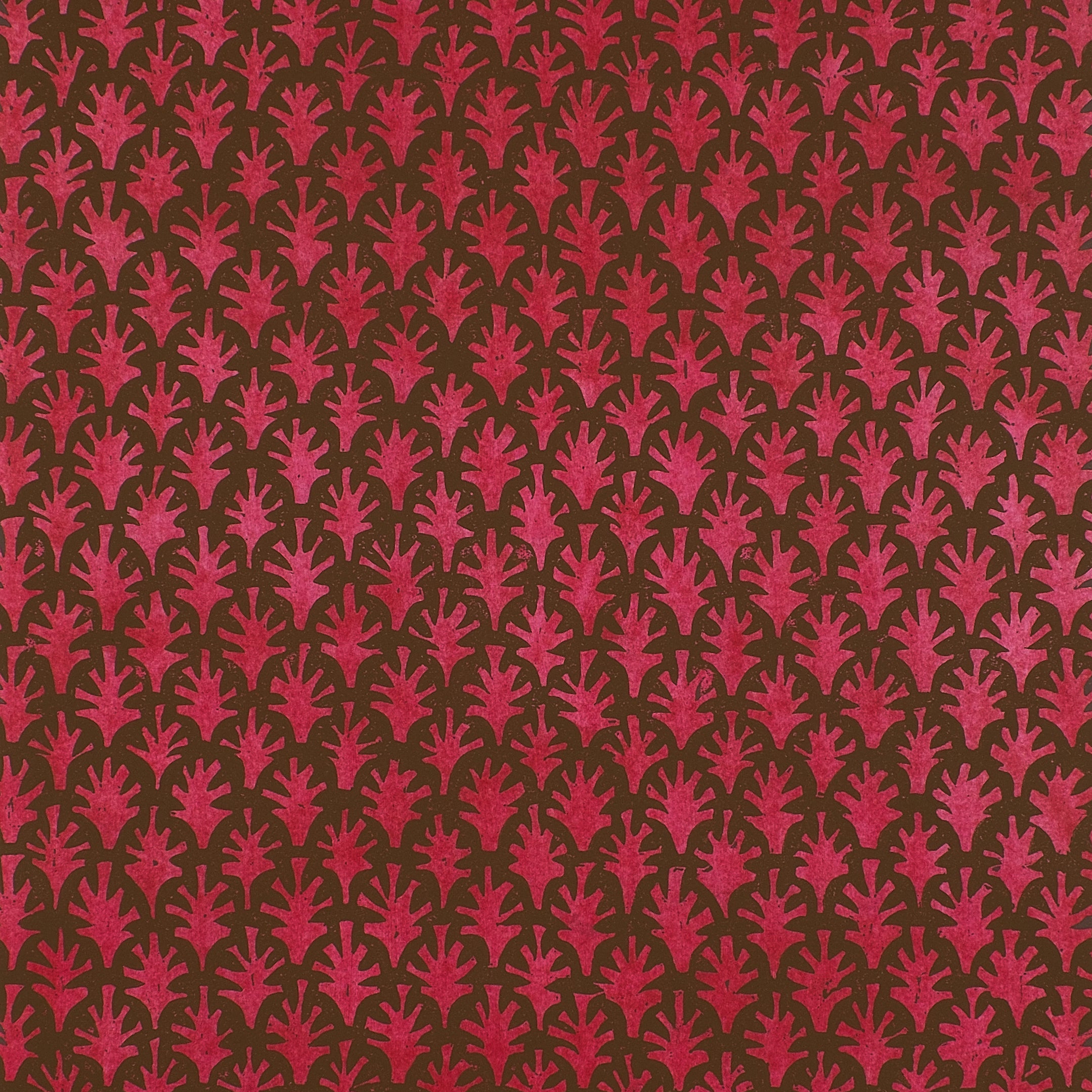 Detail of wallpaper in a repeating botanical grid print in red on a brown field.