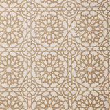 Detail of fabric in a small-scale lattice print in tan on a cream field.