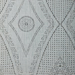 Detail of fabric in a dotted geometric print in gray on a light gray field.