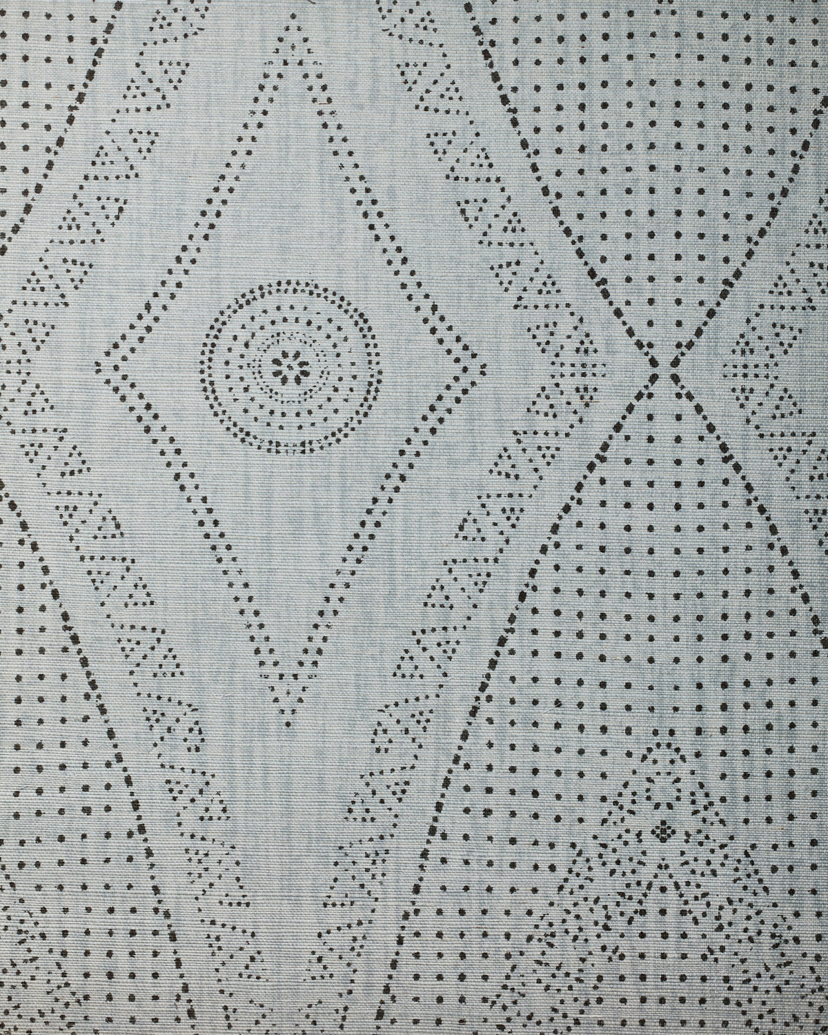 Detail of fabric in a dotted geometric print in gray on a light gray field.