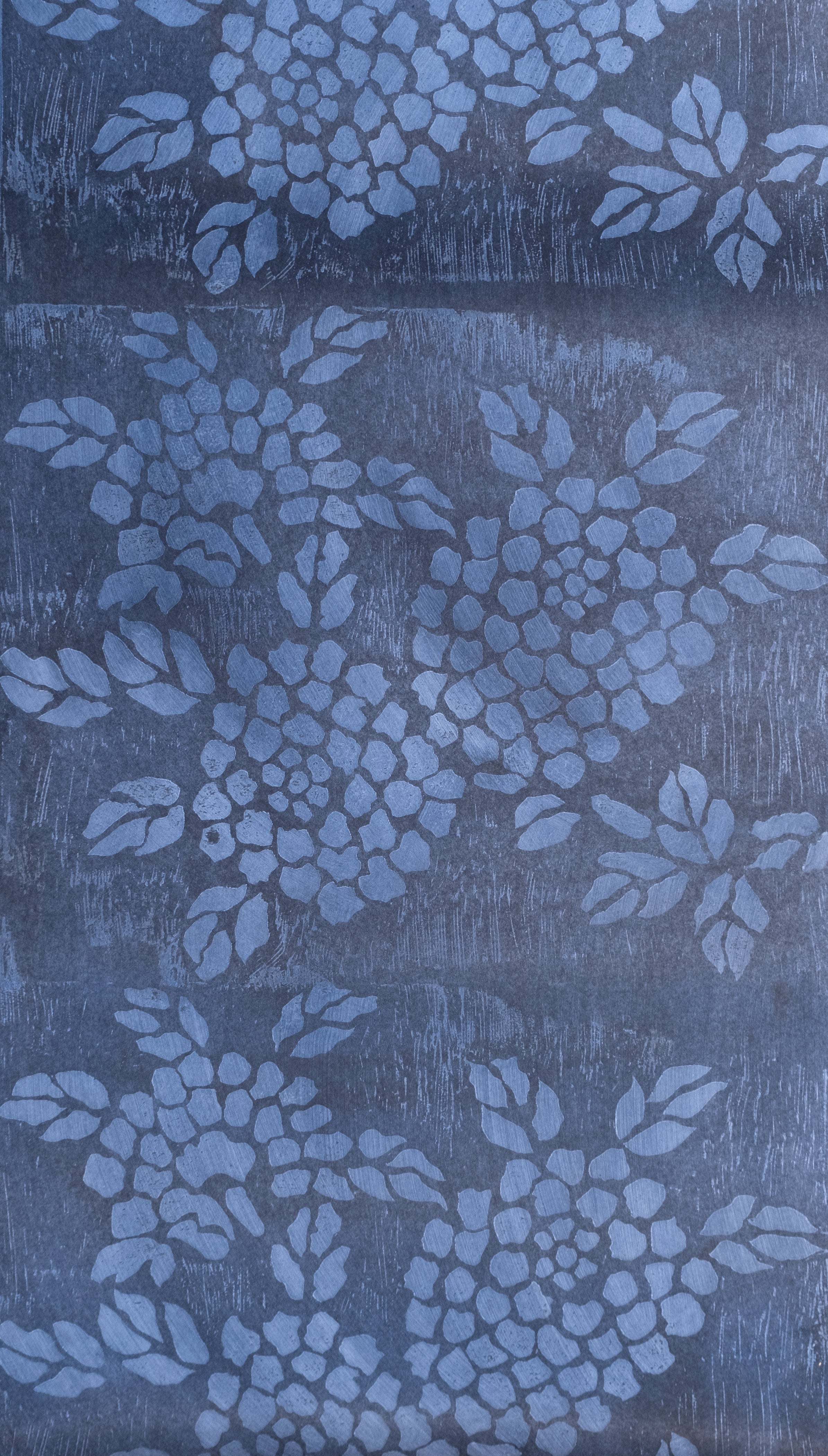 Detail of wallpaper in a minimalist floral print in blue on a mottled navy field.
