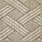 Close up of a woven lattice design carpet in beige.