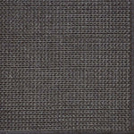 Close-up of a textured woven performance carpet in dark brown.