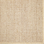 Close-up of a textured woven performance carpet in beige.