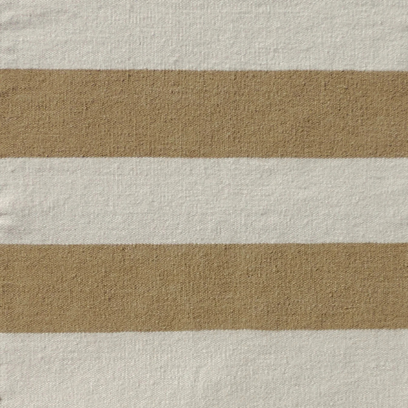 Handwoven rug with wide stripes in cream and tan. 