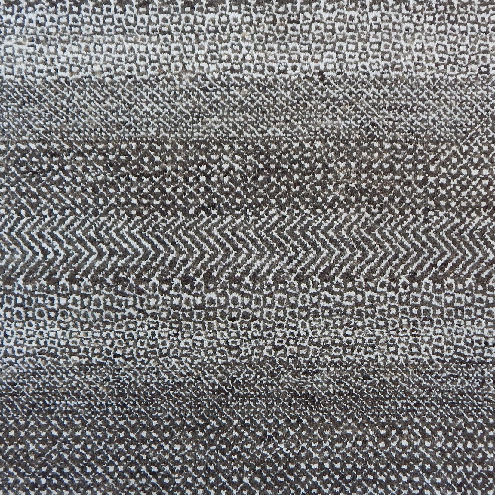 Handknotted rug with small scale geometric pattern in dark brown and ivory. 