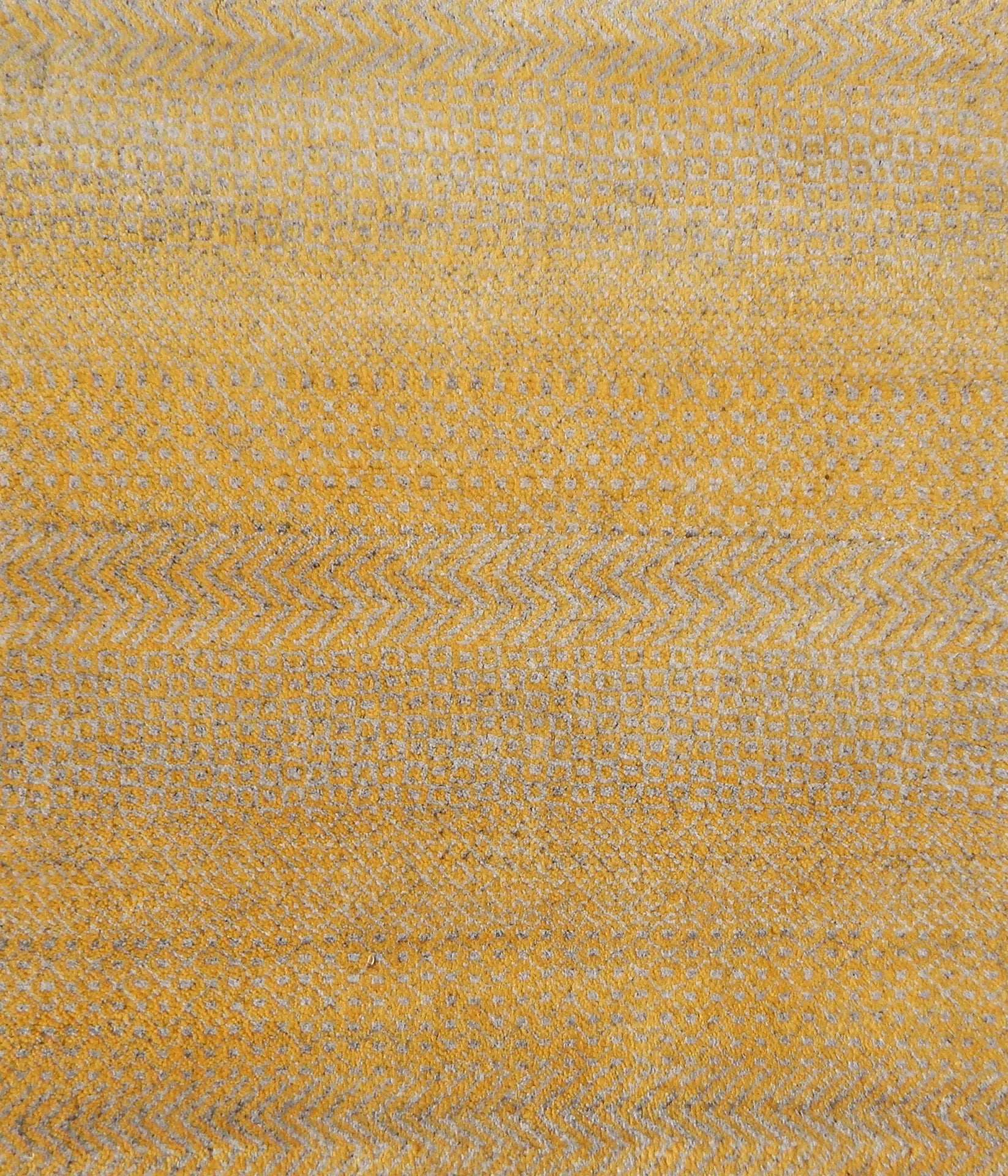 Handknotted rug with small scale geometric pattern in yellow and beige. 