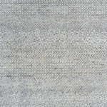 Handknotted rug with small scale geometric pattern in light grey.