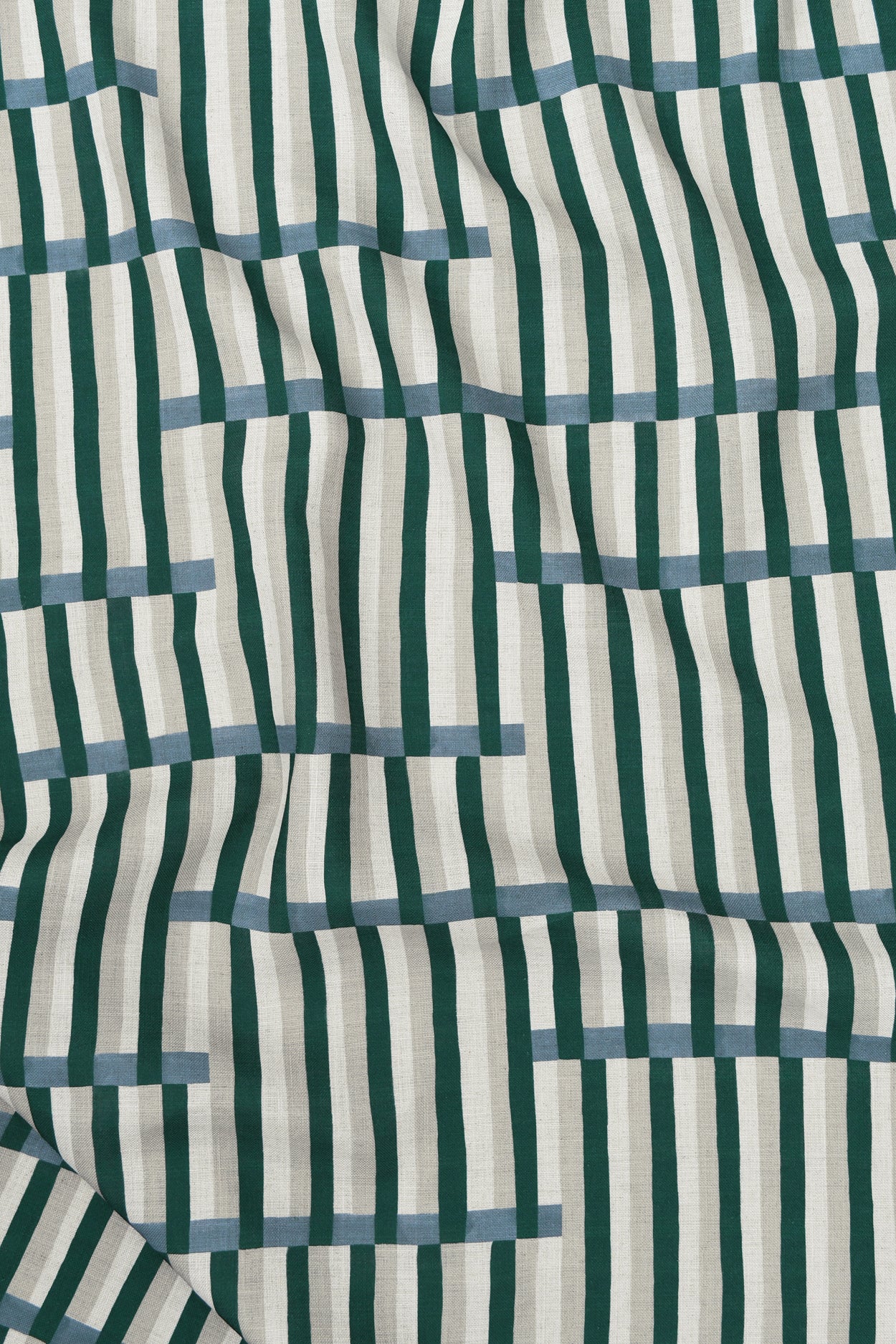 Gently draped printed linen in a broken stripe design in teal, ocean blue, ecru and cream. 