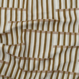 Gently draped printed linen in a broken stripe design in brown, blush pink, ecru and cream. 