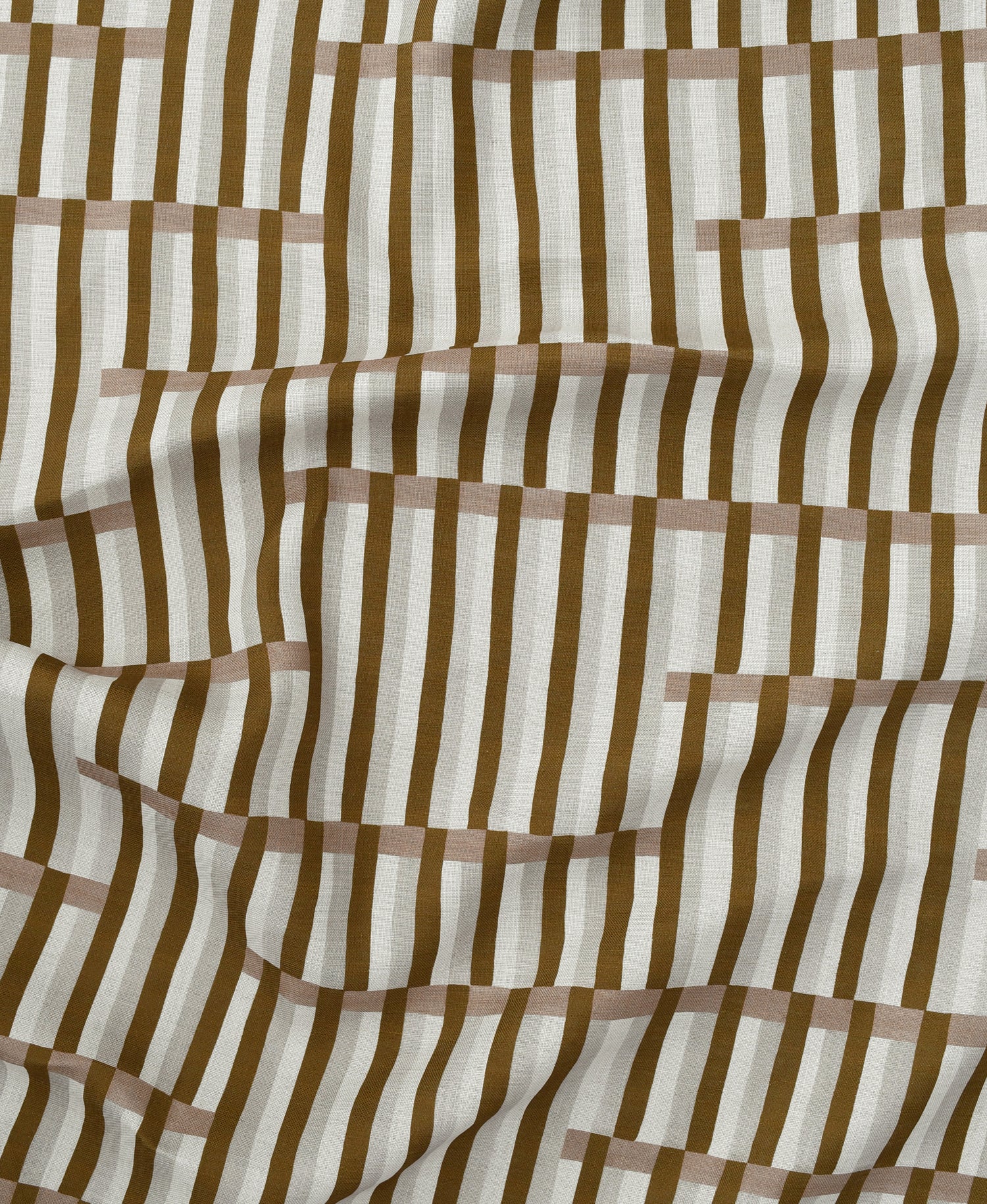 Gently draped printed linen in a broken stripe design in brown, blush pink, ecru and cream. 