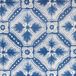 Detail of fabric in a painterly botanical grid in shades of navy on a cream field.