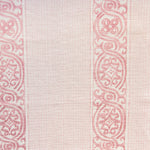 Detail of fabric in a painterly stripe print in shades of pink on a cream field.