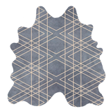 Detail of a cowhide rug in blue-gray with a tan geometric overlay.