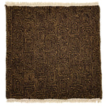 A flat weave rug sample with cream-colored fringe at top and bottom and  geometric maze-like pattern in tan and dark brown. 
