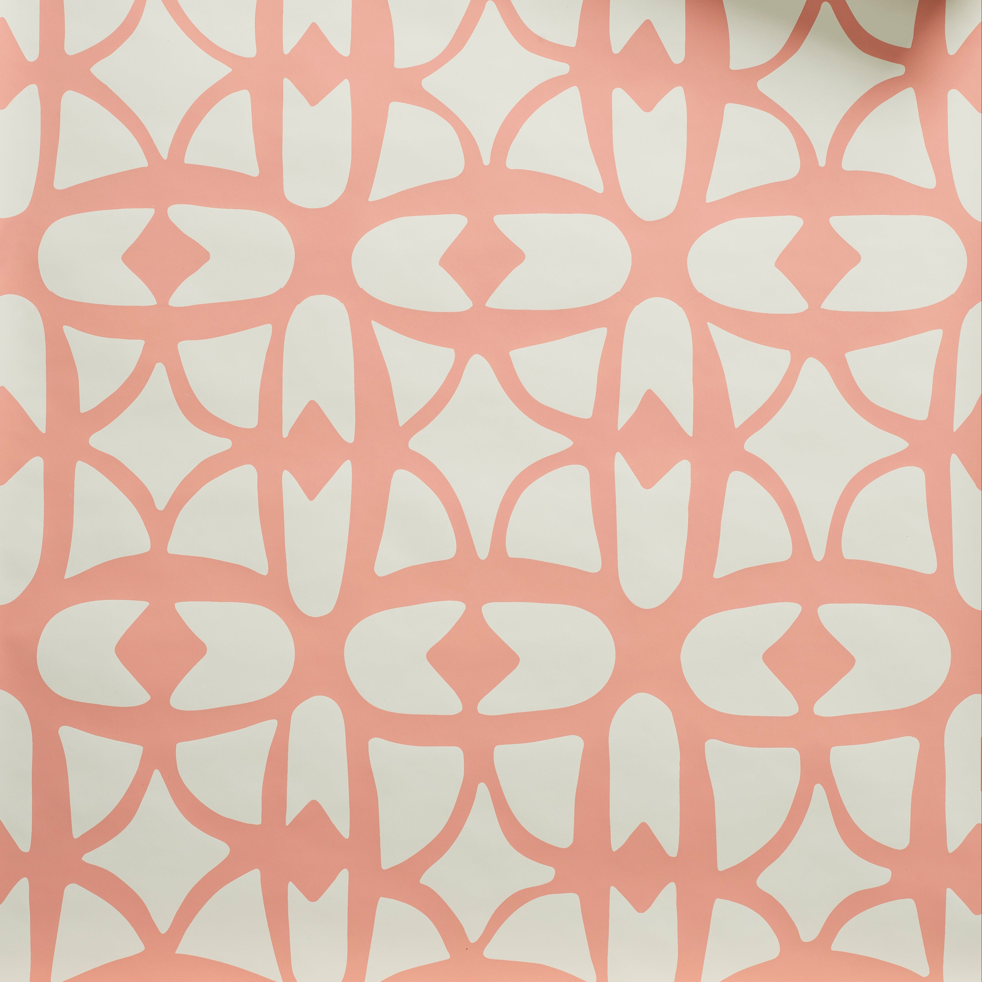 Close up of wallpaper with large scale playful geometric lattice pattern in pink on a white background. 