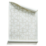 Roll of wallpaper with large scale playful geometric lattice pattern in beige and white on a white background.
