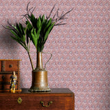 Vintage-style wallpaper with intricate patterns, a brass vase with greenery on a wooden dresser.