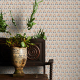 Decorative wallpaper with a subtle floral pattern, a vintage wooden chair, and a plant on a wooden surface.