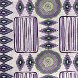 Detail of fabric in a playful geometric stripe print in shades of purple with green accents.