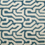Detail of wallpaper in a playful meandering print in cream on a navy field.
