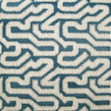 Detail of wallpaper in a playful meandering print in cream on a navy field.
