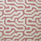 Detail of fabric in a playful meandering print in cream on a dusty rose field.