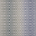 Broadloom carpet with a white checkerboard pattern with an ombré effect in blue and green. 