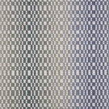 Broadloom carpet with a white checkerboard pattern with an ombré effect in blue and green. 