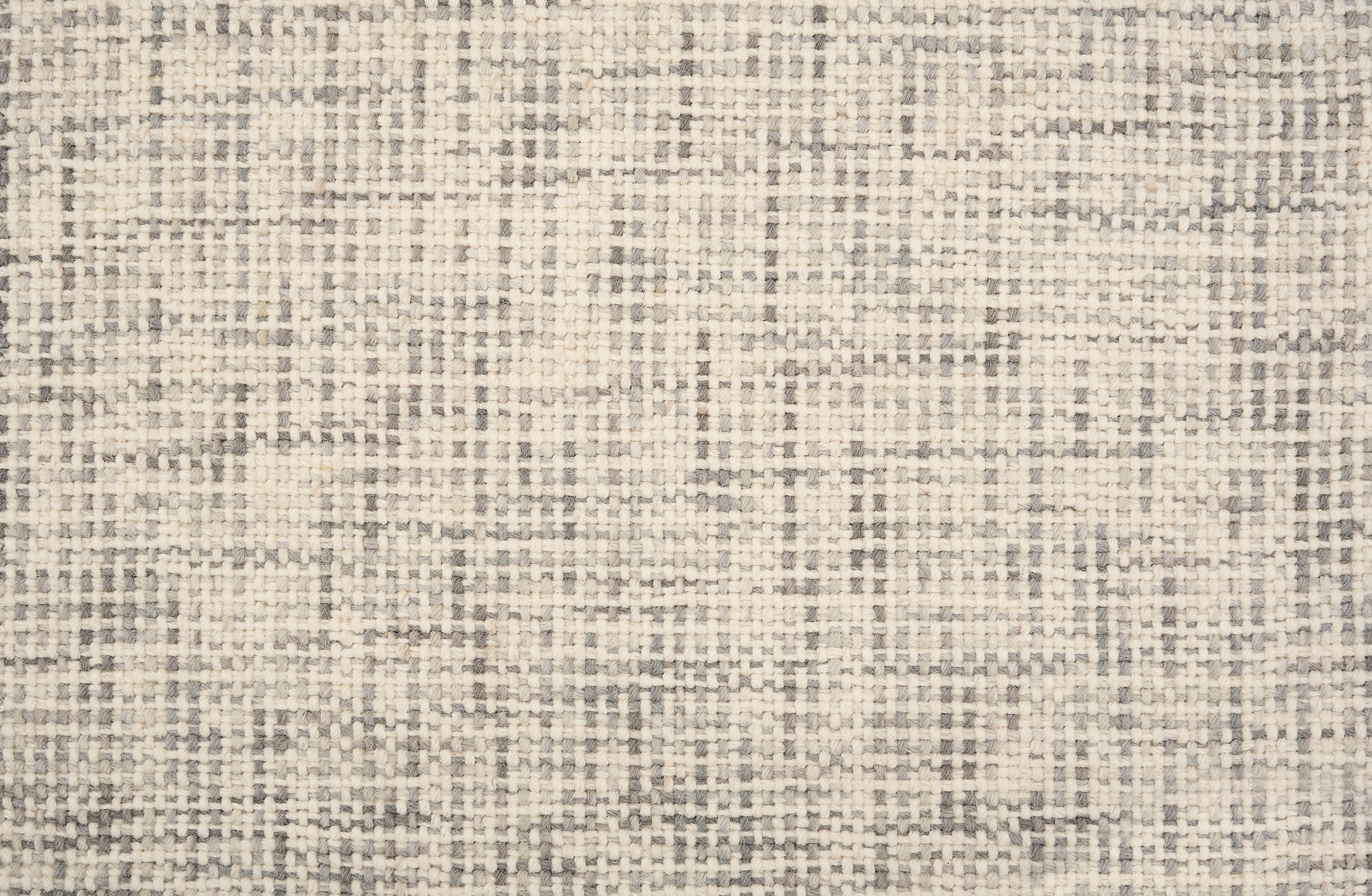 Broadloom carpet in a textural basket weave in cream mixed with grey.