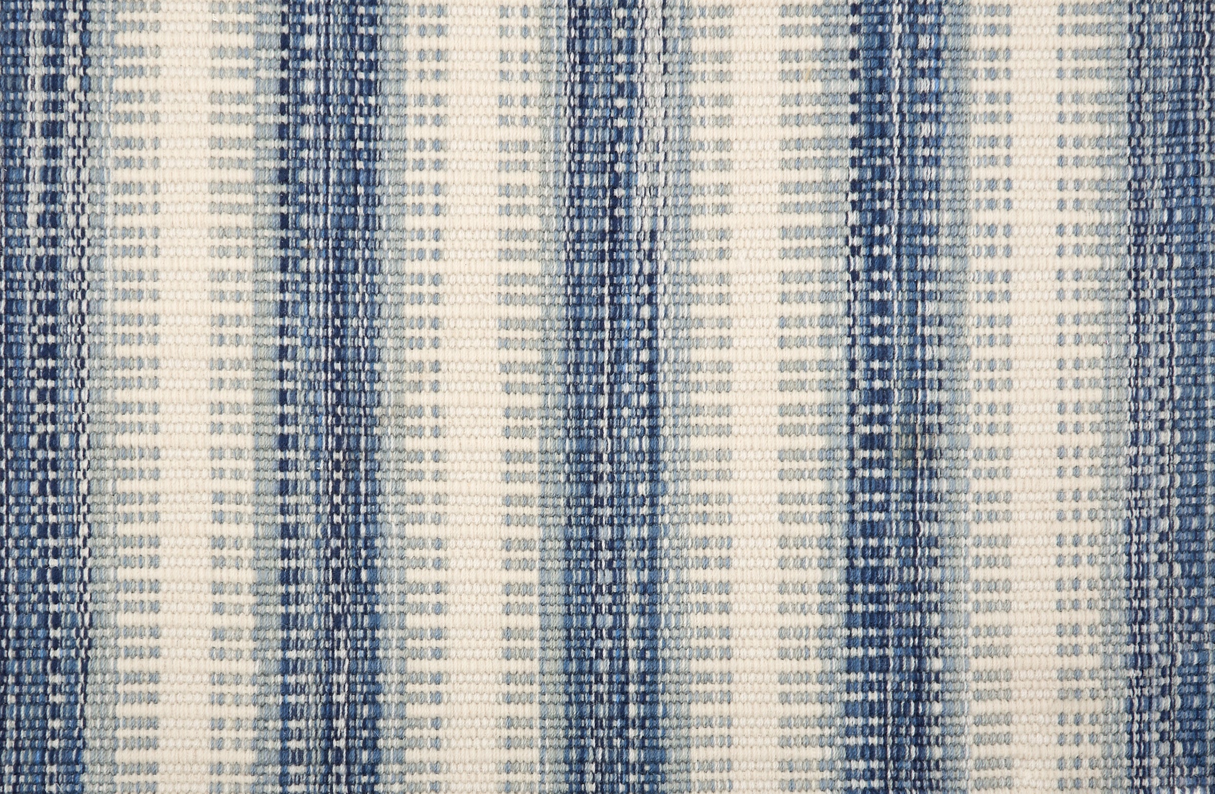 Broadloom carpet in a flatwoven stripe in light blue, cobalt and cream. 