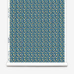 Wallpaper roll with small scale watercolor floral in green on a teal background. 