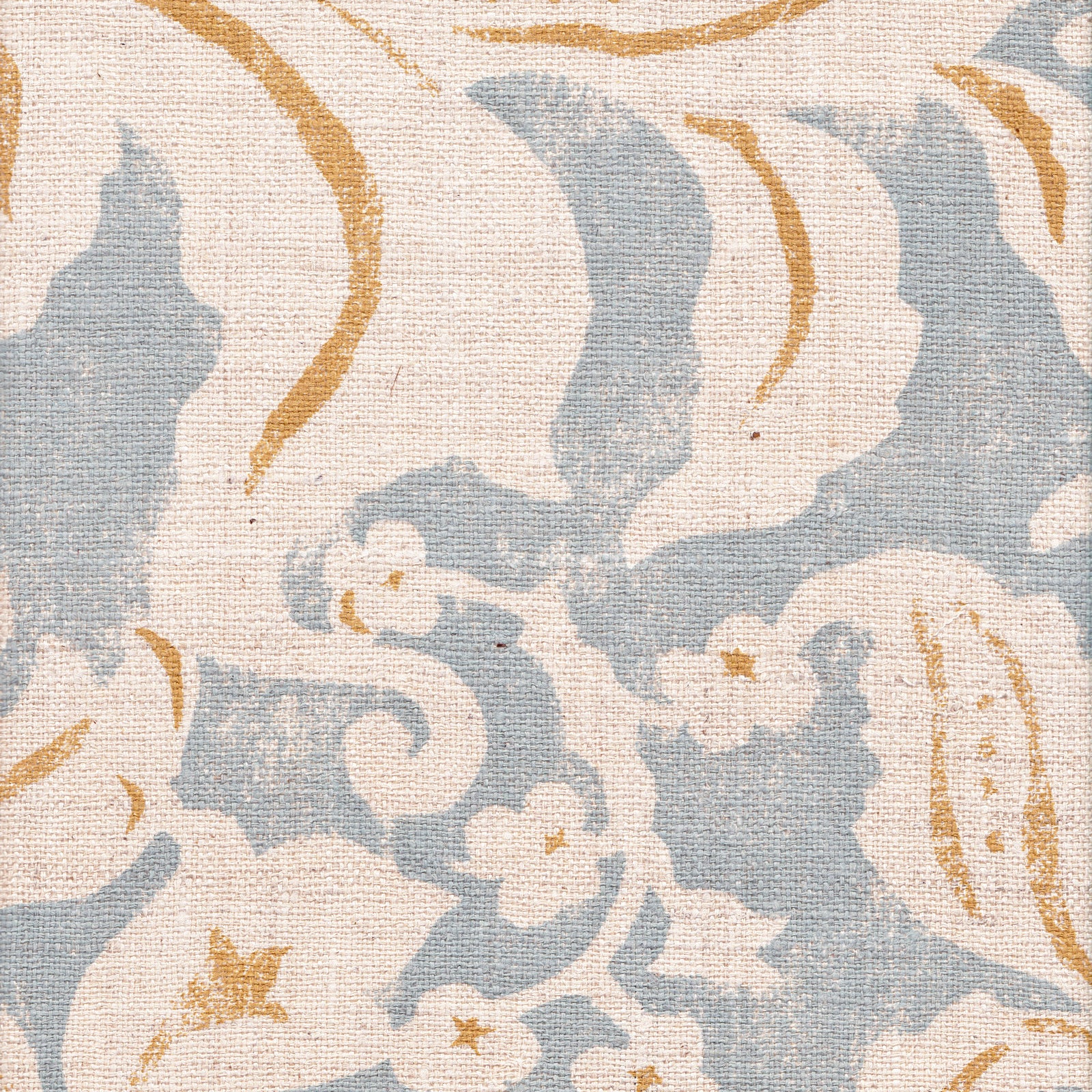 Detail of fabric in a floral damask print in white and orange on a blue field.
