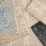 Broadloom carpet with subtle animal print in a range of colors. 