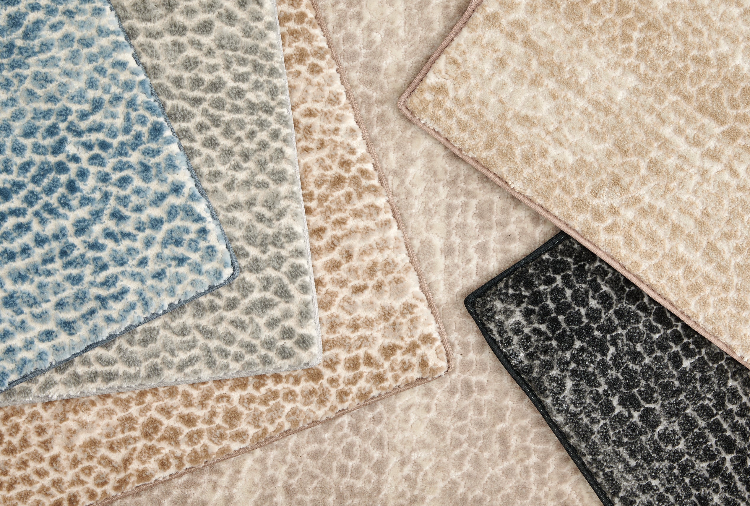 Broadloom carpet with subtle animal print in a range of colors. 