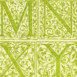 Detail of wallpaper in a playful alphabet grid print in green on a light green field.