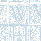 Detail of wallpaper in a playful alphabet grid print in light blue on a white field.