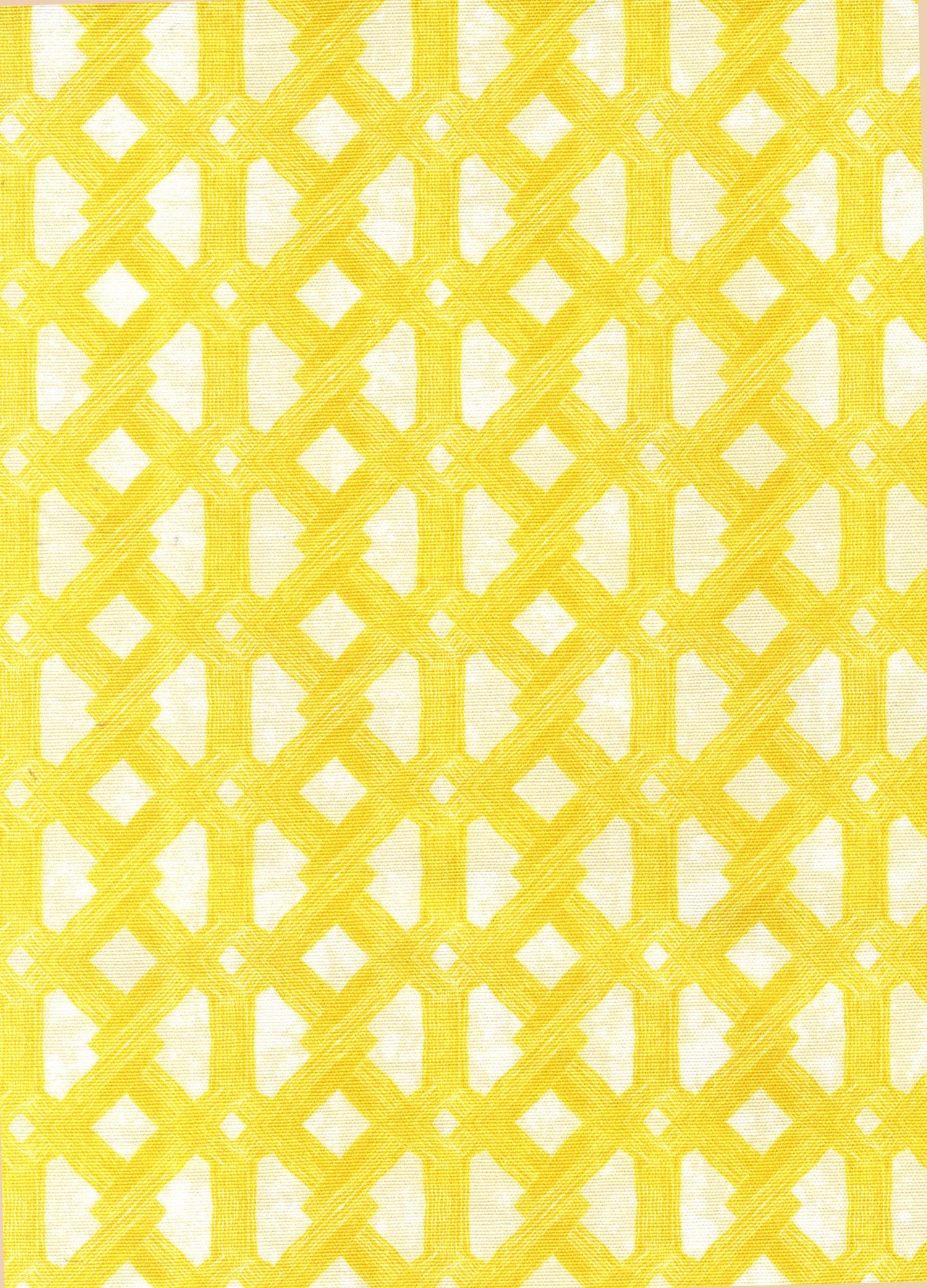 Detail of fabric in an intricate lattice print in yellow on a cream field.