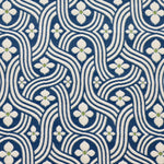 Detail of fabric in a floral damask print in white and green on a navy field.