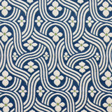 Detail of fabric in a floral damask print in white and green on a navy field.