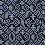 Detail of fabric in a floral damask print in blue and white on a black field.