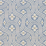 Detail of fabric in a floral damask print in white and gold on a light blue field.