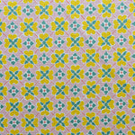 Detail of fabric in a floral lattice print in pink, yellow, teal and white.