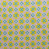 Detail of fabric in a floral lattice print in pink, yellow, teal and white.