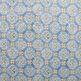 Detail of fabric in a floral lattice print in blue, green and white.