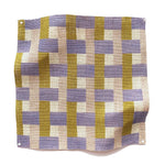 Square fabric swatch in an interlocking checked pattern in shades of pink, mustard and blue.