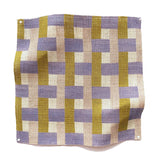 Square fabric swatch in an interlocking checked pattern in shades of pink, mustard and blue.