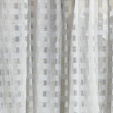 Detail of a draped sheer fabric in a check pattern in ivory.