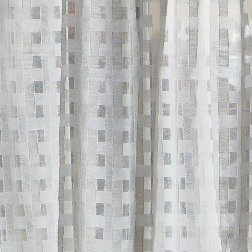 Detail of a draped sheer fabric in a check pattern in ivory.
